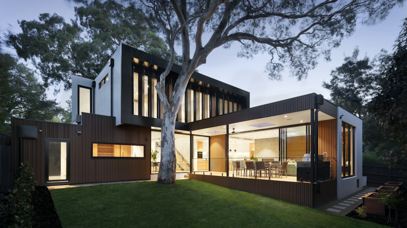 Contemporary Australian home at dusk with warm interior lighting